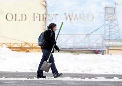 Beth Bragg carries a shovel to the Old First Ward Community Center on Saturday in Buffalo, New York.