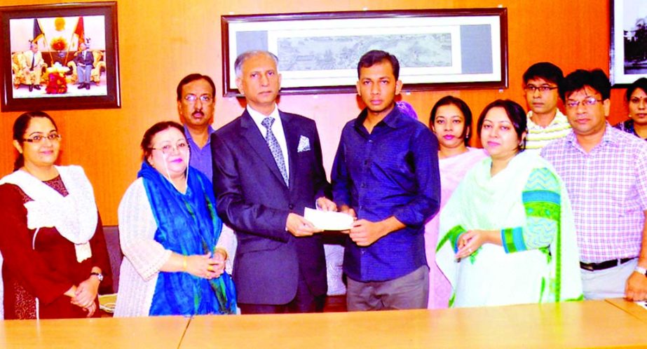 Dhaka University Vice-Chancellor Prof Dr AAMS Arefin Siddique distributing 'Advocate Md Lutfur Rahman Memorial Trust Fund Scholarship-2013' among the three students of the Department of Law of the university for their brilliant academic achievement at h