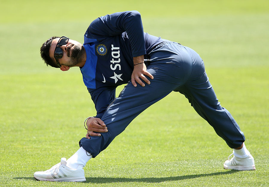 Virat Kohli stretches during India's training session at Gliderol Stadium, Adelaide on Sunday.