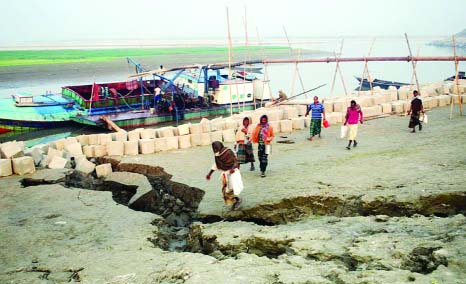 BOGRA: Illegal lifting of sand from Juman River continues at Dhunot Upazila which threatens side protection dam of the River. This picture was taken on Sunday.