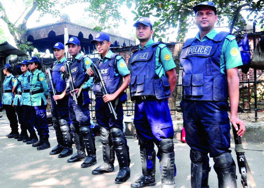 Law enforcers stand guard as part of security measures in front of the International Crimes Tribunal in the city on Monday centering verdict against war criminal Mobarak Hossain.