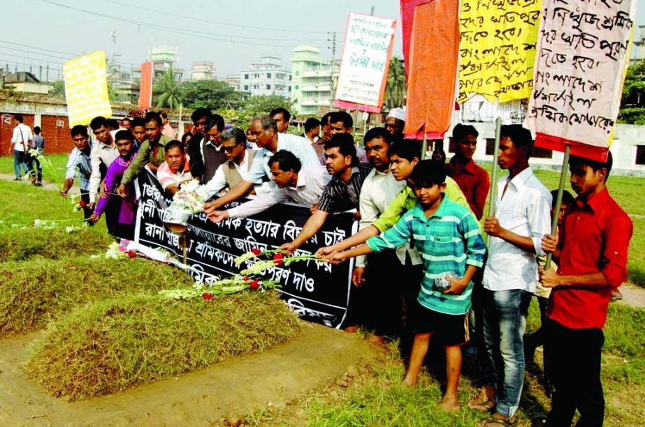 Garments Sramik Sangram Parishad paying tributes to the deceased who were killed in Rana Plaza collapse and Tazreen fire incident by placing floral wreaths on their graves. The snap was taken from the city's Jurain Graveyard on Monday.