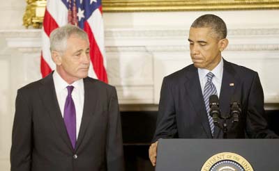 US President Barack Obama, standing with Defence Secretary Chuck Hagel, talks about Hagel's resignation during an event at the White House on Monday.