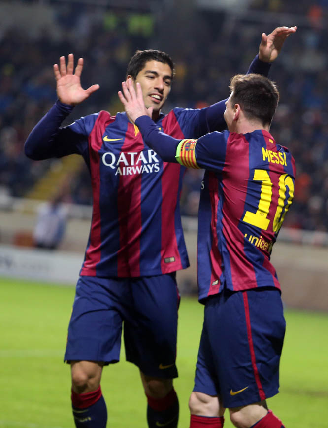 Barcelona's Lionel Messi (right) is congratulate by his teammate Luis Suarez after scoring against APOEL during the Champions League Group F soccer match between Apoel and Barcelona, at GSP stadium in Nicosia, Cyprus on Tuesday.