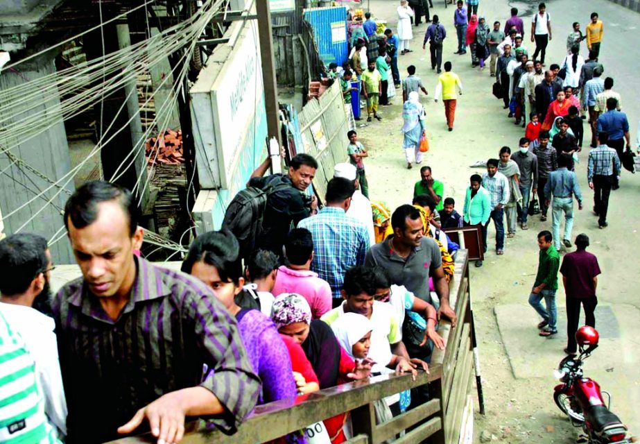 In a bid to avoid penalties by the DMP, the pedestrians formed queues to use the foot-over bridge near Bangla Motor in city on Wednesday-the 3rd day of the crackdown on jaywalkers.