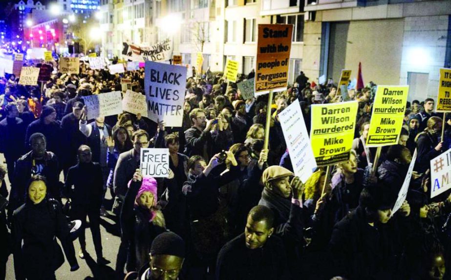 Thousands march in protest on the streets of Washington, DC, on Tuesday one day after a grand jury decision not to prosecute a white police officer for the killing of an unarmed black teen in Ferguson.