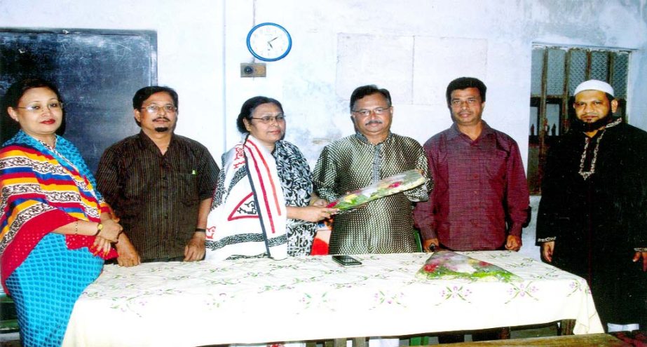Headmistress of Patharika High School Mrs Momtaz Begum presenting bouquet to newly -elected Chairman of the Managing Committee at a function at Chittagong recently.