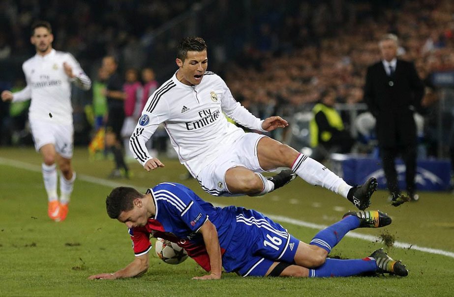 Cristiano Ronaldo is tackled hard by Basle's Fabian Schar during their Champions League group B soccer match between Switzerland's FC Basel 1893 and Spain's Real Madrid CF in the St Jakob-Park stadium in Basel, Switzerland on Wednesday.
