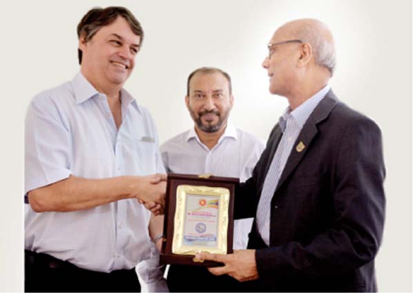 Mirza Salman Ispahani, Managing Director, Ispahani Group of Companies and Chairman of the Managing Committee of Mirza Ahmed Ispahani High School handing over a crest to Education Minister Nurul Islam Nahid MP on Wednesday.