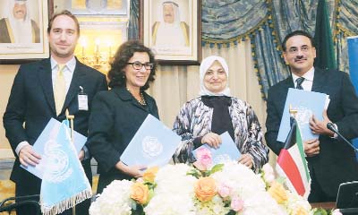 Kuwait Minister of Social Affairs and Labour and Minister of Planning Hind al-Sabeeh (second right), Michael Niusen from the International Organisation for Migration (left), Nada al-Nashef from the International Labour Organisation (second left) and Mubas