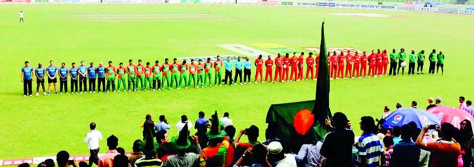 Players from both teams observe a minute's silence in memory of Phillip Hughes at the Sher-e-Bangla National Stadium on Friday.