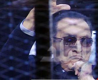 Ousted Egyptian President Hosni Mubarak sits in the defendant cage during his trial at a court in Cairo, Egypt on Saturday.