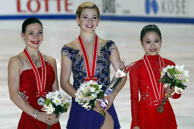 Winner Gracie Gold (center) of the United States second-placed Alena Leonova (left) of Russia and third-placed Satoko Miyahara of Japan pose for photographers during awarding ceremony of the womenâ€™s skating of the NHK Trophy figure skating in Osaka