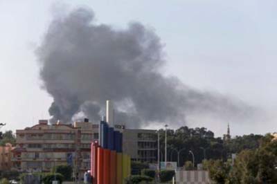 Black smoke billows in the sky above areas where clashes are taking place between pro-government forces, who are backed by the locals, and the Shura Council of Libyan Revolutionaries, an alliance of former anti-Gaddafi rebels, who have joined forces with