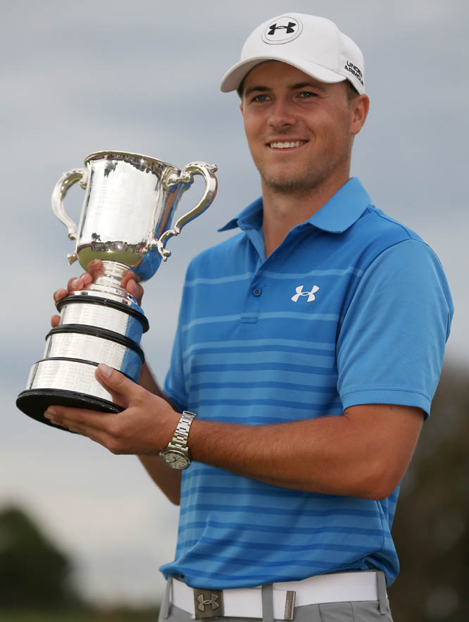 Jordan Spieth of the US holds the Stonehaven Cup as he celebrates winning the Australian Open golf championship in Sydney on Sunday. Spieth's four-round total of 13-under 271 on the tough, windy Australian Golf Club made him the first American to win the