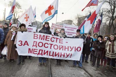 Protesters carry a banner reading "Together for decent medicine!" as they march in a street in Moscow, Russia on Sunday.