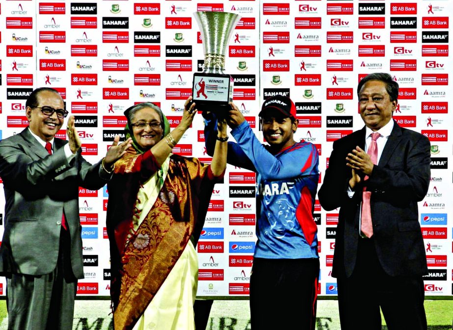 Prime Minister Sheikh Hasina and Mushfiqur Rahim pose with the winning trophy at the Sher-e-Bangla National Cricket Stadium in Dhaka on Monday.
