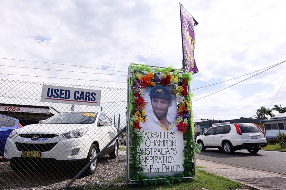 A tribute to Phillip Hughes outside a used-cars dealership at Macksville on Tuesday.