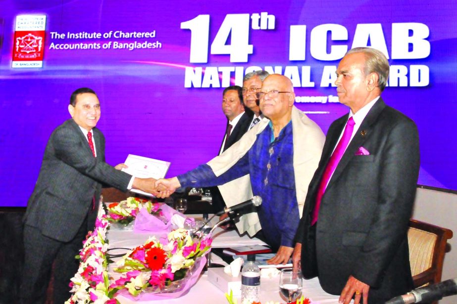 Finance Minister Abul Maal Abdul Muhith presenting ICAB Certificate of Merit Award for the best presented annual reports-2013 to Shamsul Huda Khan, Managing Director (Current Charge) of National Bank Limited at a city hotel recently.