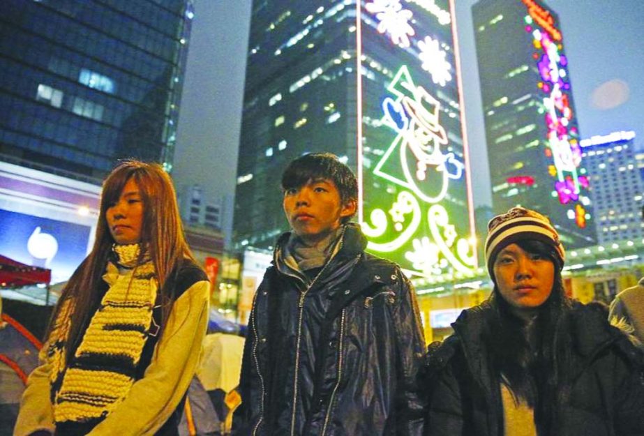 Three students, from right, Prince Wong, Joshua Wong and Isabella Lo walk at the occupied area outside government headquarters during their hunger strike in Hong Kong on Wednesday.