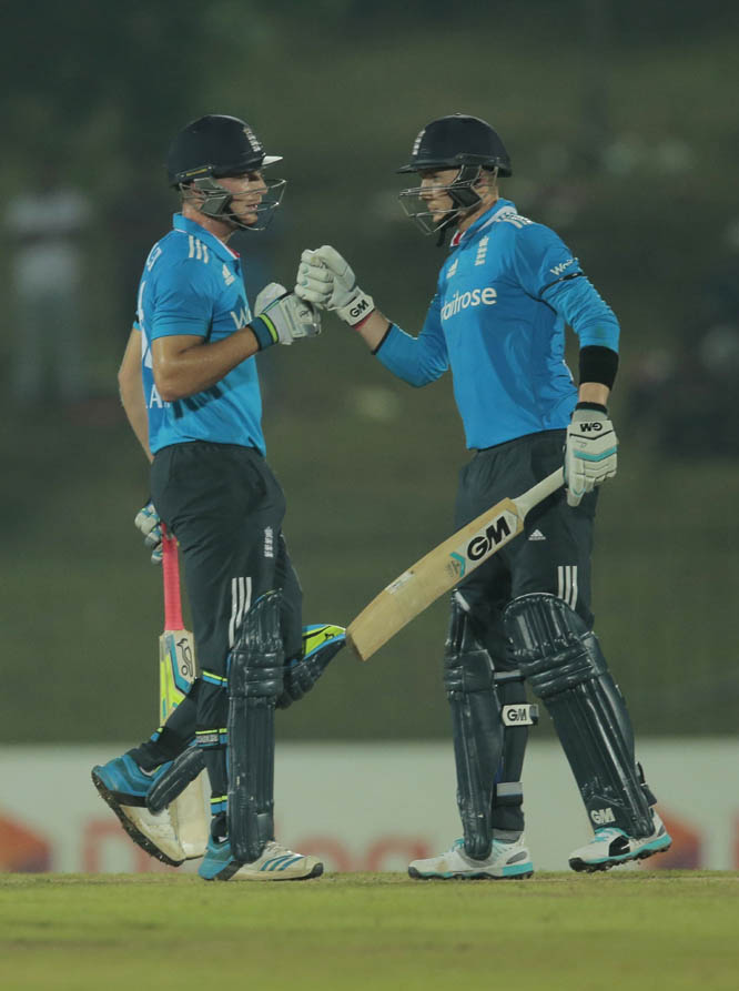 England's Joe Root (left) and Jos Buttler celebrate their teams victory over Sri Lanka by five wickets in the third One Day International cricket match in Hambantota, Sri Lanka on Wednesday.