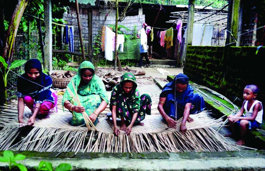 SYLHET: Women are making bamboo made materials to dry paddy. This picture was taken from Hariyarchar village of South Surma Upazila on Thursday.