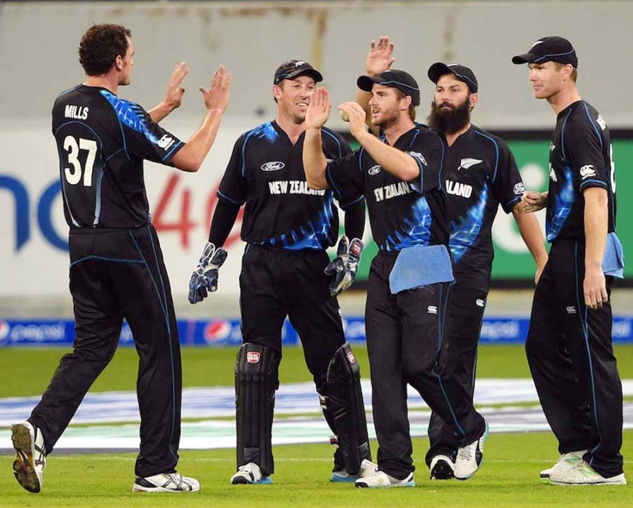 New Zealand bowler Kyle Mills (C) celebrates with teammates after taking the wicket of Pakistani batsman Anwar Ali during the second and last International T20 cricket match at Dubai International Stadium in Dubai on Friday.