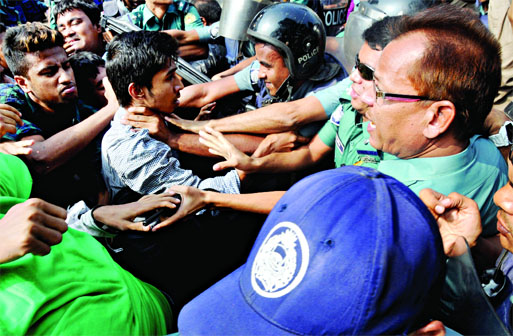 Policemen caught a student by throat when he along with others tried to march towards Prime Minister's Office demanding 2nd chance for admission into Undergraduate Course in public universities including Dhaka University. This photo was taken from city'