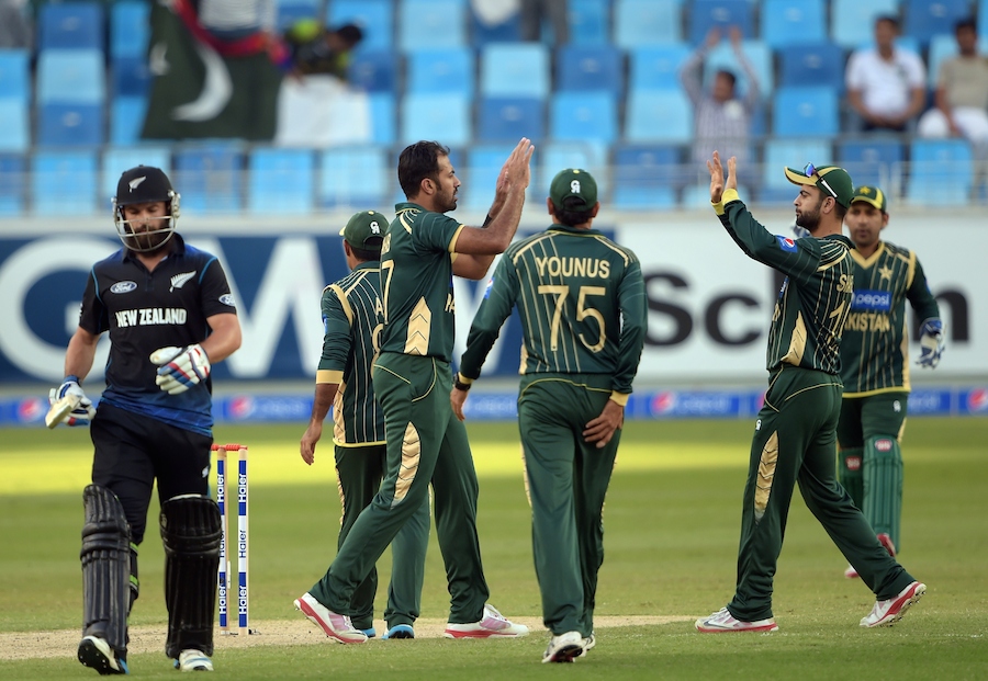 Pakistani cricketers celebrate after the dismissal of New Zealand batsman Anton Devcich (L) during the first One Day International cricket match between Pakistan and New Zealand at Dubai International Stadium in Dubai on Monday.New Zealand scored 246 for