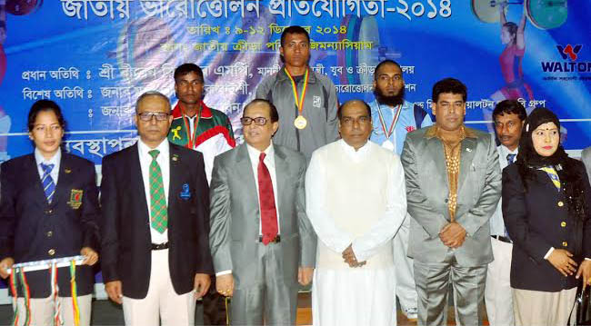 The winners of the 15th National Junior Weightlifting Competition with the chief guest State Minister for Youth and Sports Biren Sikder, MP pose for a photograph at the Gymnasium of National Sports Council on Monday.