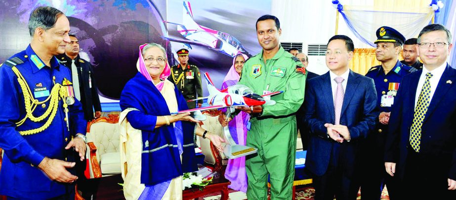 Prime Minister Sheikh Hasina being presented the model of K-8W Trainer Aircraft at its induction ceremony to Bangladesh Air Force at BAF Base Bangabandhu in the city's Kurmitola on Wednesday. BSS photo