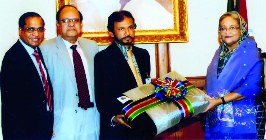 M Sahabuddin Ahmed, Chairman of Dutch-Bangla Bank Foundation, handing over the sample of one lac blanket to Prime Minister Sheikh Hasina at Gonobhaban on Wednesday. KS Tabrez, Managing Director and Abul Kashem Md Shirin, Deputy Managing Director of the ba