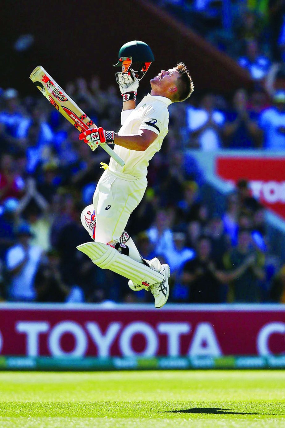 David Warner breaks into his trademark leaping celebration after reaching his hundred on the 4th day of 1st Test between Australia and India at Adelaide on Friday.