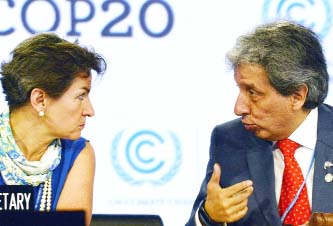 UNFCCC Executive Secretary Christiana Figueres (L) listens to the COP20 President and Peruvian Minister of Environment Manuel Pulgar on Friday.