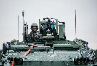 A soldier from the Swedish Armed Forces, looks on from top of a Patria XA-360 AMV at Hagshult Airbase near Malmo.