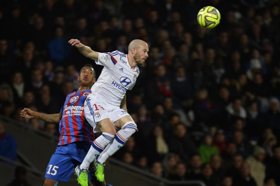 Lyon's French defender Christophe Jallet (R) vies with Caen's French Beninese defender Emmanuel Imoroue during the French L1 football match between Olympique Lyonnais and Caen on Friday in Lyon.