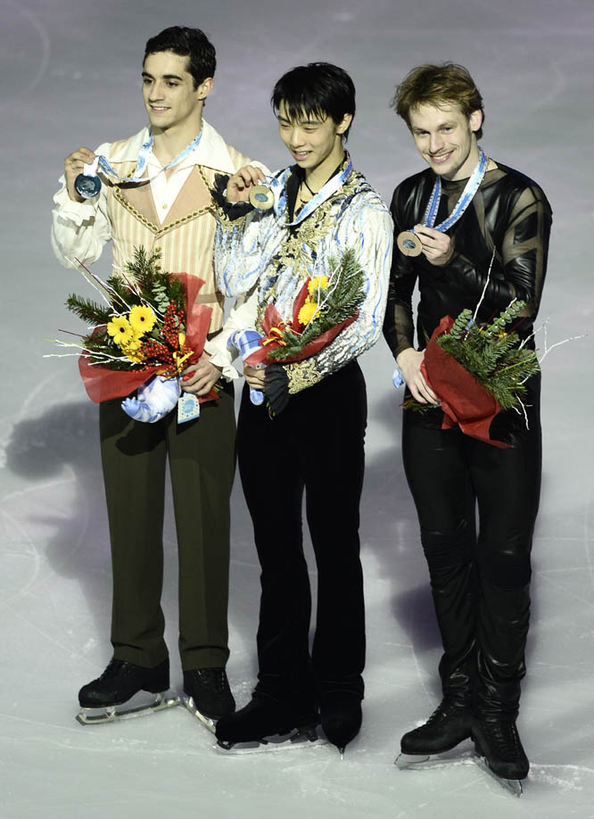 Yuzuru Hanyu of Japan (center) Javier Fernandez of Spain (left) and Sergei Voronov of Russia (right) celebrate their positions at the podium of the Men Free Skating during the Grand Prix Final figure skating competition in Barcelona, Spain on Saturday.