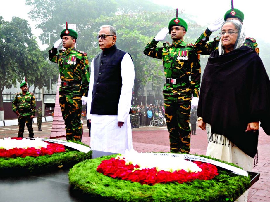 President Abdul Hamid and Prime Minister Sheikh Hasina standing in silence after placing wreaths at the altar in Mirpur Graveyard marking the Martyred Intellectuals' Day on Sunday.