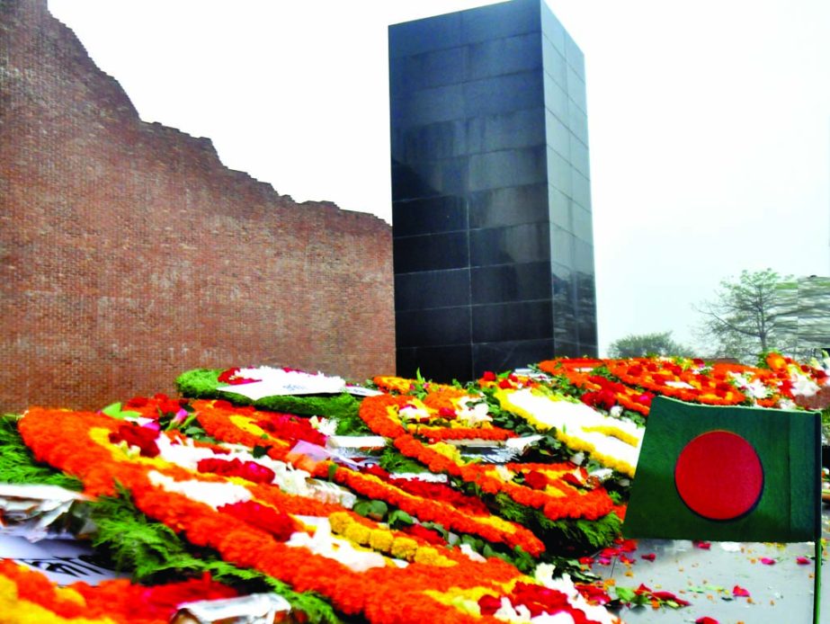 BOUQUETS OF LOVE: Rayer Bazar killing spot of the Martyred Intellectuals turned into a flower garden when thousands bedecked the Altar with wreaths on Sunday.