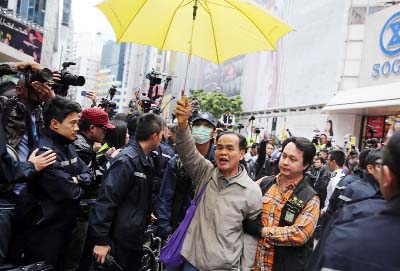 A protester is arrested after refusing to leave the pro-democracy protest site being cleared by police in the Causeway Bay district of Hong Kong on Monday.