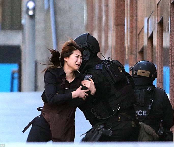 A young female employee came nunning out of the Sydney cafe sieged by Islamist-link group taking hostage its employees and customers on Monday. (News on Page-1).