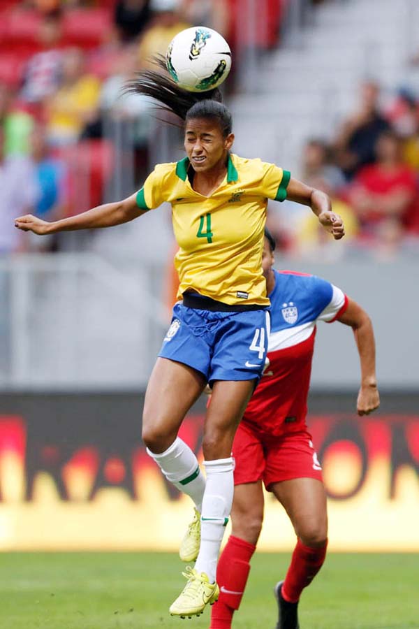 Brazilâ€™s Tayla Carolina, foreground, (4) fights for the ball with United States' Sydney Leroux, during a match of the International Women's Football Tournament at the National Stadium in Brasilia, Brazil on Sunday.