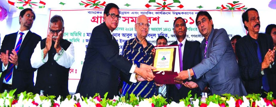 Finance Minister AMA Muhith, receiving a crest from Md Yeasin Ali, Chairman, Qazi Murshed Hossain Kamal, Director and Dr Md Zillur Rahman, Managing Director of Bangladesh Development Bank Ltd on the occasion of Business Promotion and Customers Gathering-2