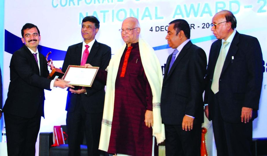 Finance Minister AMA Muhith handing over award to United Commercial Bank Limited for Corporate Governance Excellence 2013 by the Institute of Chartered Secretaries of Bangladesh recently.