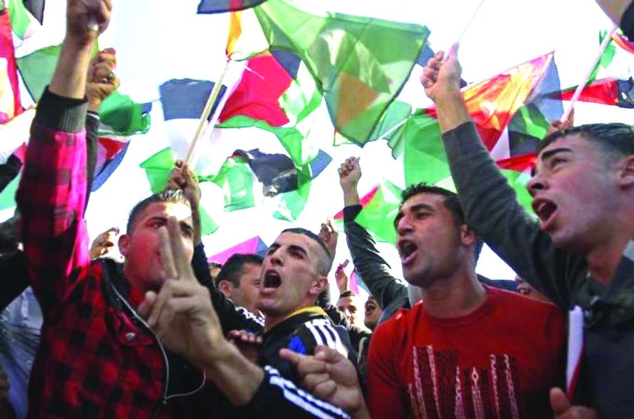 Palestinian men take part in a demonstration on Monday in Gaza City.