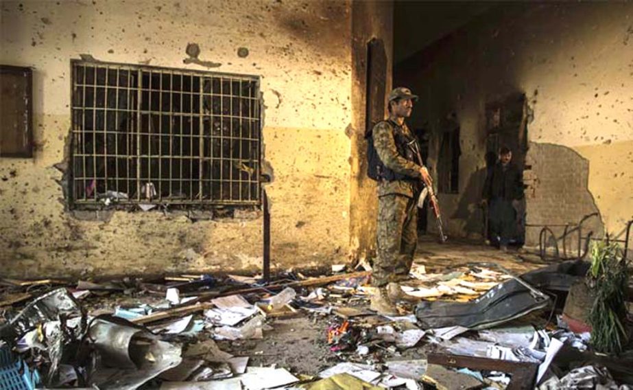 An army soldier stands inside the Army Public School, which was attacked by Taliban gunmen, in Peshawar on Tuesday.