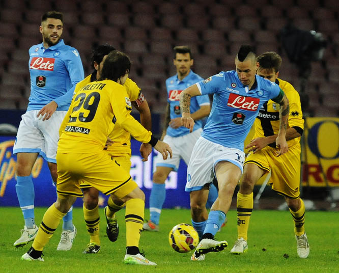 Napoli's Marek Hamsik (right) dribbles among Parma players during a Serie A soccer match between Napoli and Parma, at the San Paolo stadium in Naples, Italy on Thursday.