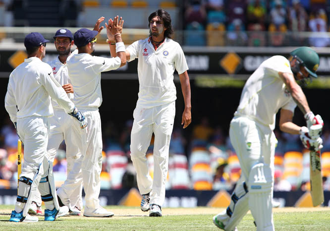India's Ishant Sharma (second right) celebrates with his team after getting the wicket of Australia's Mitchell Johnson (right) on the third day of the second cricket test in Brisbane, Australia on Friday.