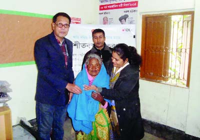 DINAJPUR(South): Polli Sree, an NGO distributing blankets among cold-hit people at Phulbari upazila on Thursday.