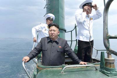 North Korean leader Kim Jong Un stands on the conning tower of a submarine during his inspection of the Korean People's Army Naval Unit 167.